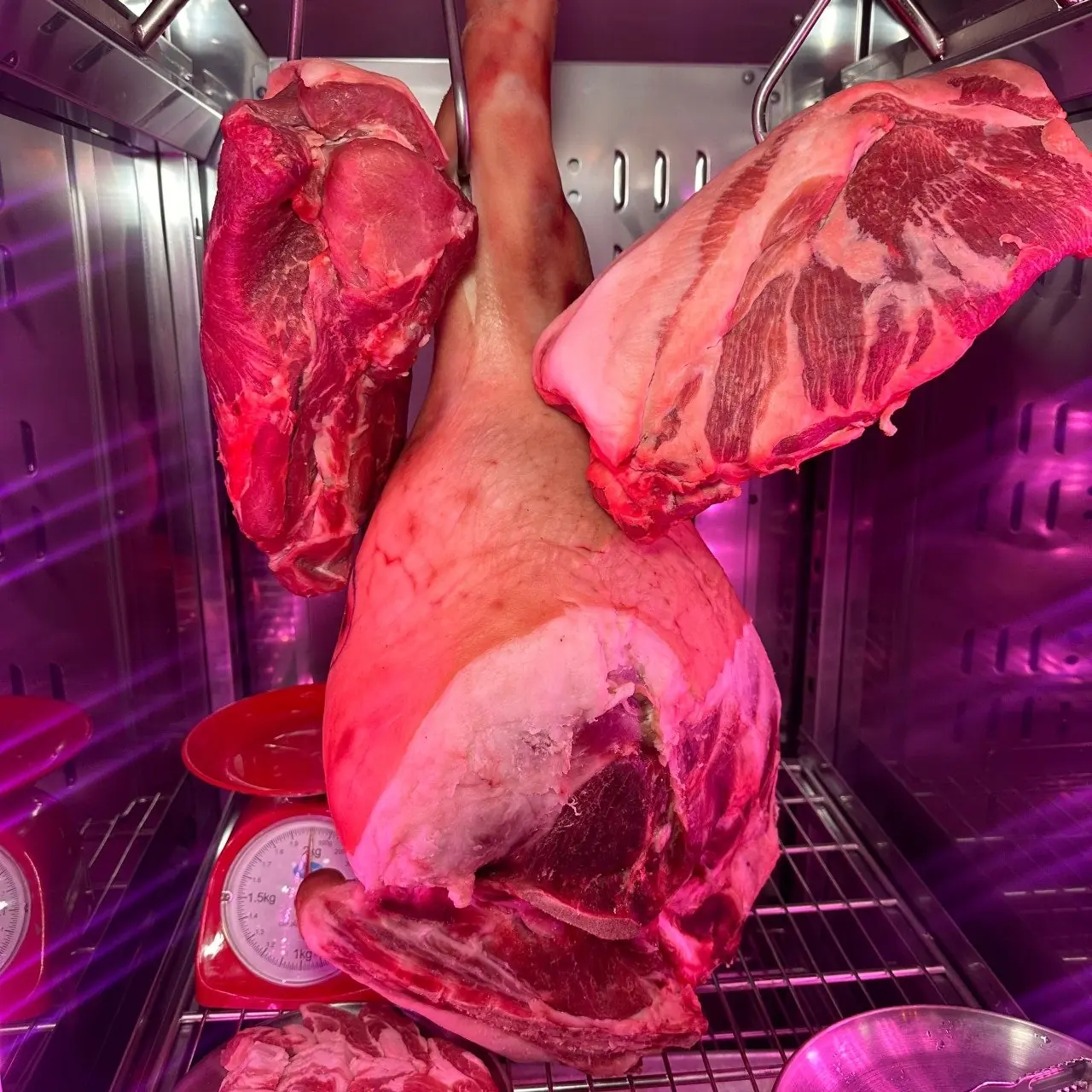 김숙성 홍대점 숙성고에 걸린 원육 — dry-aged whole cuts hanging in the aging room of Kim Sukseong Hongdae, a Hongdae restaurant serving cross-aged Korean BBQ